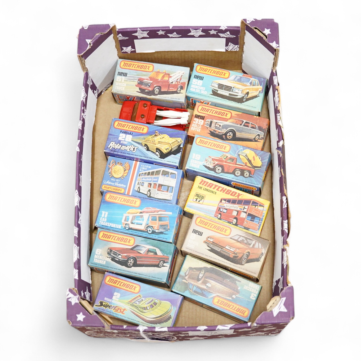 Twelve boxed Matchbox Superfast and Rola-matics 1-75 vehicles; rescue hovercraft (2), Porsche turbo (3), Mercedes tourer (6), Rover 3500 (8), car transporter (11), the Londoner bus (17), Silver Jubilee bus, cement truck